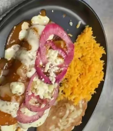 Entrée with pickled red onions, rice and beans