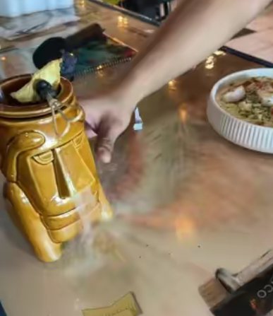 A smoking tiki mug and a dessert plate